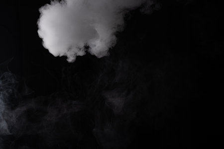 Cloud of white smoke on a black background closeupの写真素材