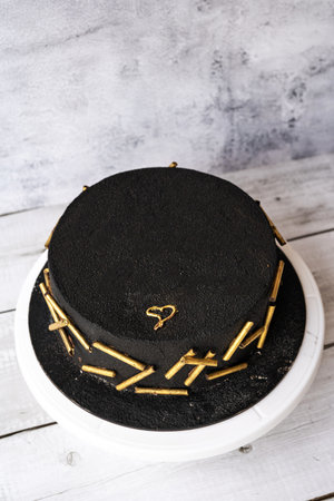 Festive cake in black color top view.の写真素材