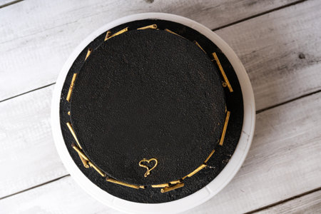 Festive cake in black color top view.の写真素材