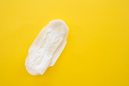 Womens sanitary napkin on a yellow background close-up.の写真素材