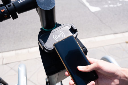 Tarragona, Spain - June 12, 2022: Steering wheel with a qr code for renting an electric scooter...