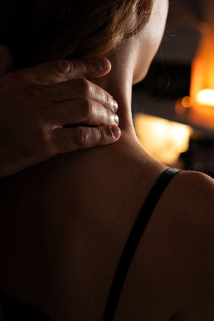 Close-up of male hands doing lymphatic drainage massage on a female neck.