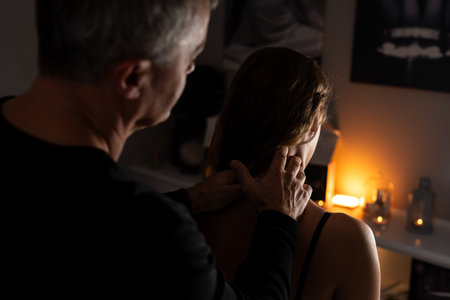 Close-up of male hands doing lymphatic drainage massage on a female neck.の写真素材