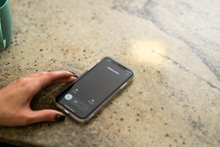 Fraud or fraudulent schemes. Close-up of a womans hand holding a phone with an unexpected incoming...