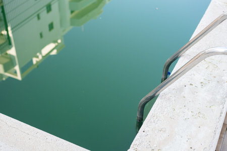 Swimming pool with green water close-up.の写真素材
