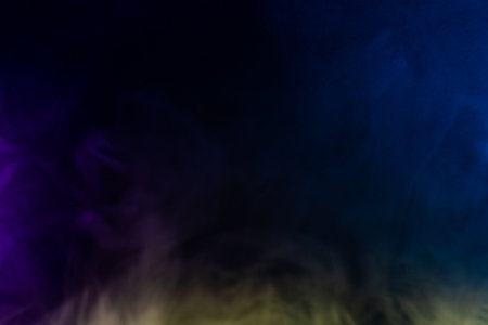 Blurred photo texture of colored smoke on a black background.の写真素材