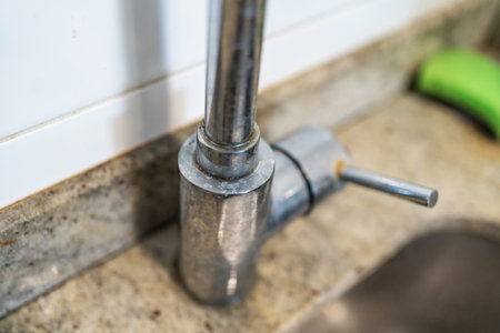 Dirty kitchen sink faucet contaminated with calcium and dirt.の写真素材