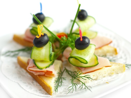 Close-up canape with ham, cucumbers and olive の写真素材