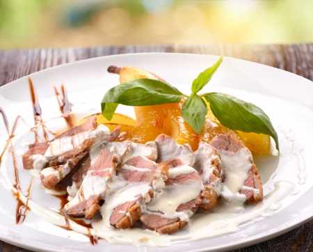 Roasted duck breast with banana on the plateの写真素材