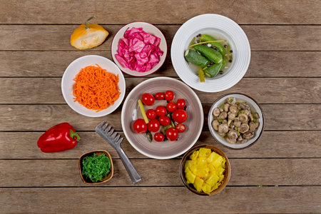 the vegetables in the plate on wooden background top viewの写真素材