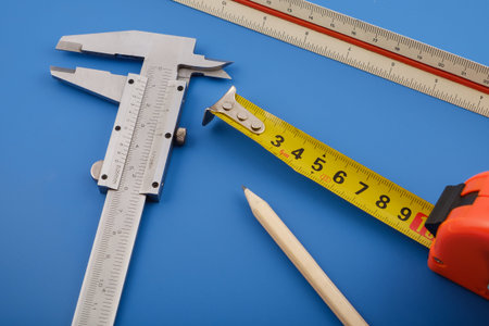 caliper, ruler and measuring tape on a table