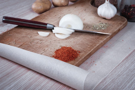 on the cutting board cut knife onion, potato and spices