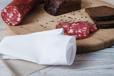 Sausage and bread on wooden surfaceの写真素材