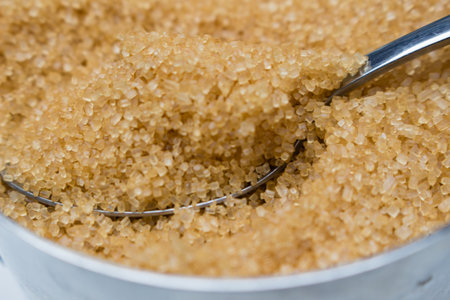 Brown sugar with a spoon in a containerの写真素材