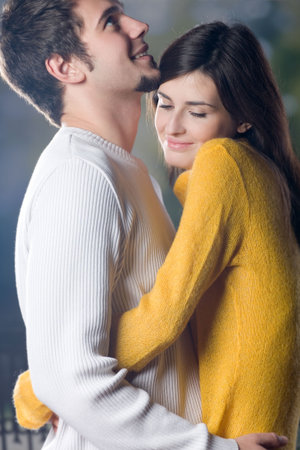Young couple embracing, outdoors