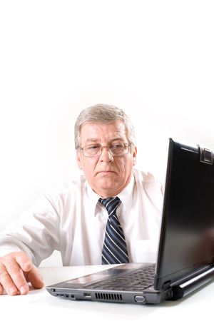 Mature puzzled business man on laptop, thinkingの写真素材