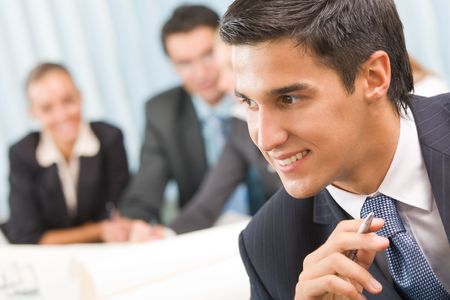 Portrait of successful businessman and business-team at office meetingの写真素材