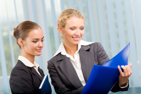 Two businesspeople working together at officeの写真素材