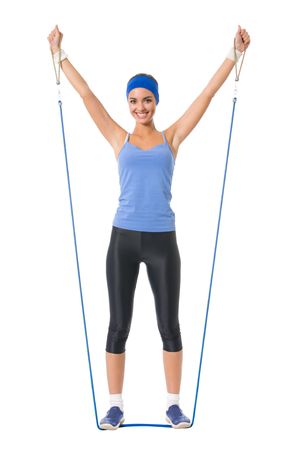 Young happy woman doing fitness exercises, isolated on whiteの写真素材
