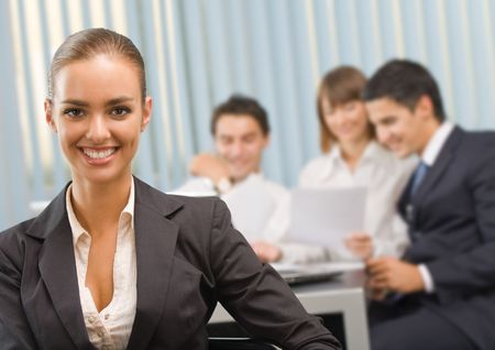 Portrait of successful businesswoman and business team at office meetingの写真素材