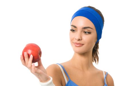 Portrait of woman in sportswear with apple, isolated on whiteの写真素材