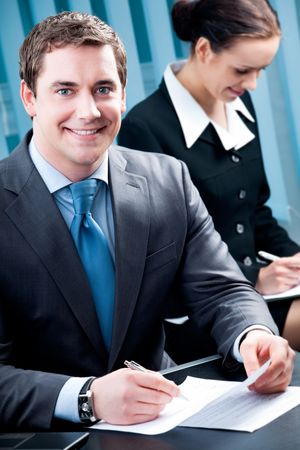 Portrait of successful businessman and colleague on background, at officeの写真素材