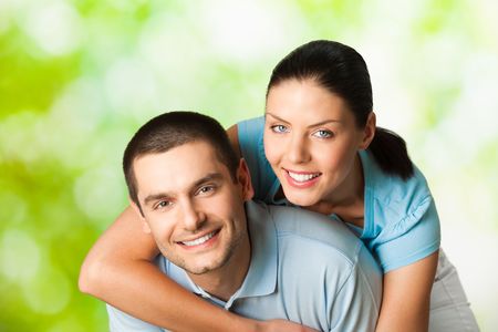 Young happy smiling attractive couple, outdoorsの写真素材
