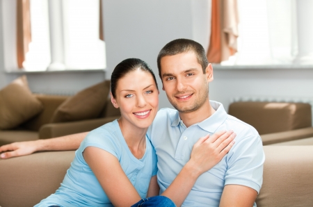Young happy smiling attractive couple at homeの写真素材