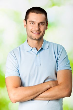 Portrait of young attractive smiling man, outdoorsの写真素材