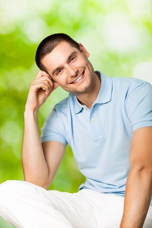 Portrait of young attractive smiling man, outdoorsの写真素材