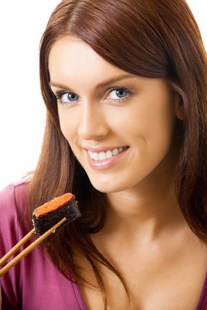 Young happy woman eating sushi roll by chopsticks, isolated on whiteの写真素材