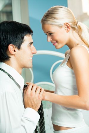 Young attractive happy amorous couple at bedroomの写真素材
