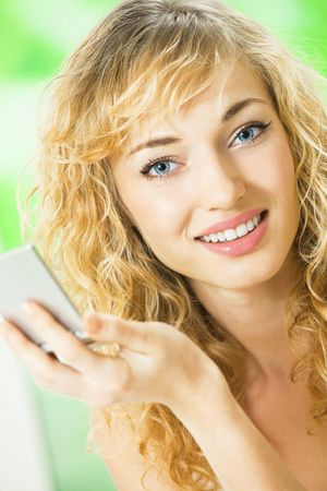 Portrait of young woman with mirror at homeの写真素材