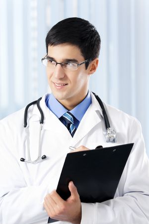 Portrait of writing doctor at officeの写真素材
