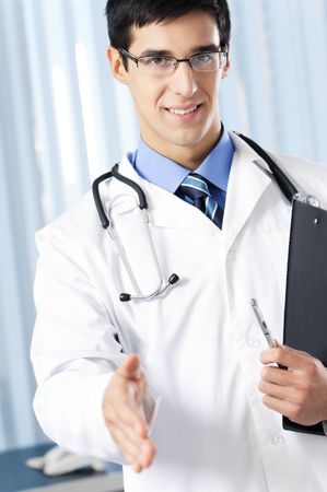 Doctor giving hand for handshake, at officeの写真素材