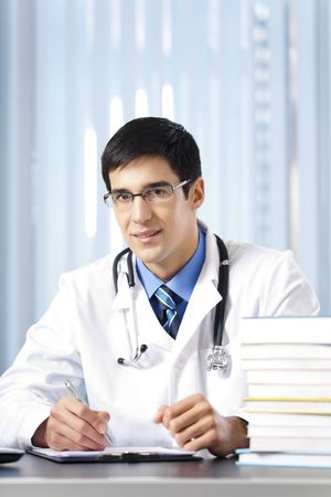 Portrait of writing doctor at officeの写真素材