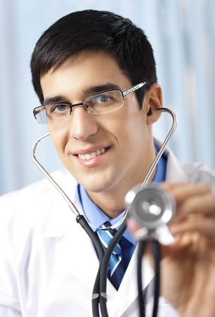Doctor with stethoscope, at officeの写真素材