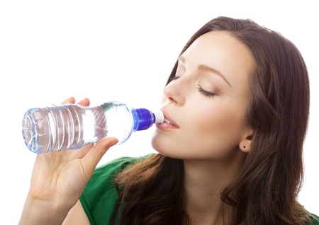Woman drinking water from bottle, isolated on white backgroundの写真素材