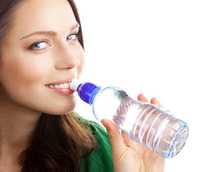 Woman drinking water from bottle, isolated on white backgroundの写真素材