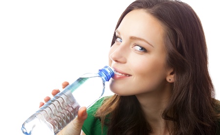 Woman drinking water from bottle, isolated on white backgroundの写真素材