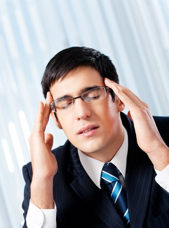 Thinking, tired or ill with headache businessman at officeの写真素材