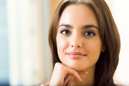 Portrait of young beautiful happy smiling woman, at homeの写真素材