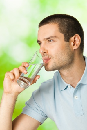 Young man drinking water, outdoorsの写真素材