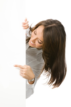 Happy smiling beautiful young business woman showing blank signboard, isolated over white backgroundの写真素材