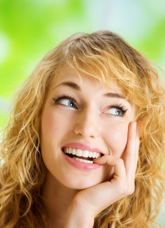 Portrait of happy cheerful smiling thinking young beautiful blond woman, indoorsの写真素材
