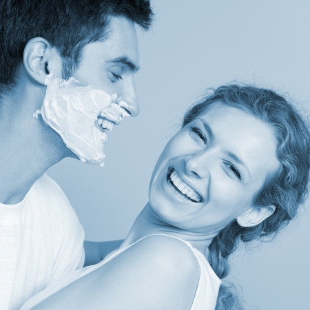 Monochrome image of a cheerful couple having a fun together, in blue toneの写真素材