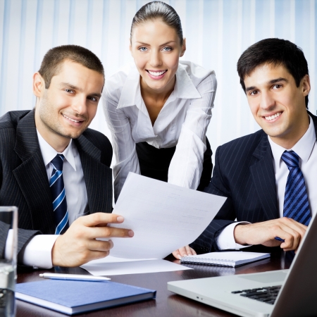 Three businesspeople working with document at office の写真素材