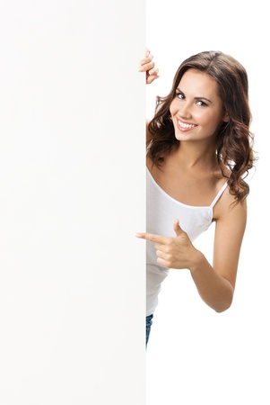 Happy smiling beautiful young woman showing blank signboard or copyspace for slogan or text, isolated over white backgroundの写真素材