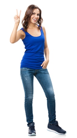 Full body portrait of happy smiling beautiful young woman showing two fingers or victory gesture, isolated over white backgroundの写真素材