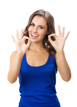 Happy smiling beautiful young woman showing okay gesture, isolated over white backgroundの写真素材